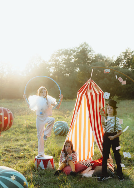 A colorful, circus-inspired canopy, kids playing.