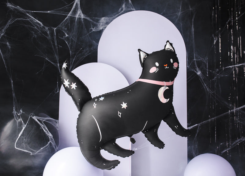 Black cat balloon with star and moon designs on a dark background with spider webs on background