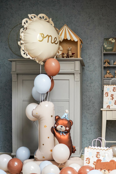 decorative set up showing number 1 balloon with bear foil