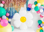 Colorful balloon arch with flower balloon and tinsel decorations on a white background
