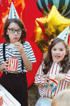 kids eating from Circus themed snack boxes