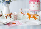 Tea party table setting with horse-themed paper snack boxes on table