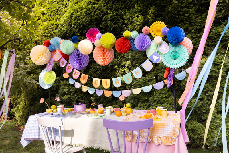Tissue paper scalloped garland detail showing colorful half-circle fan decorations