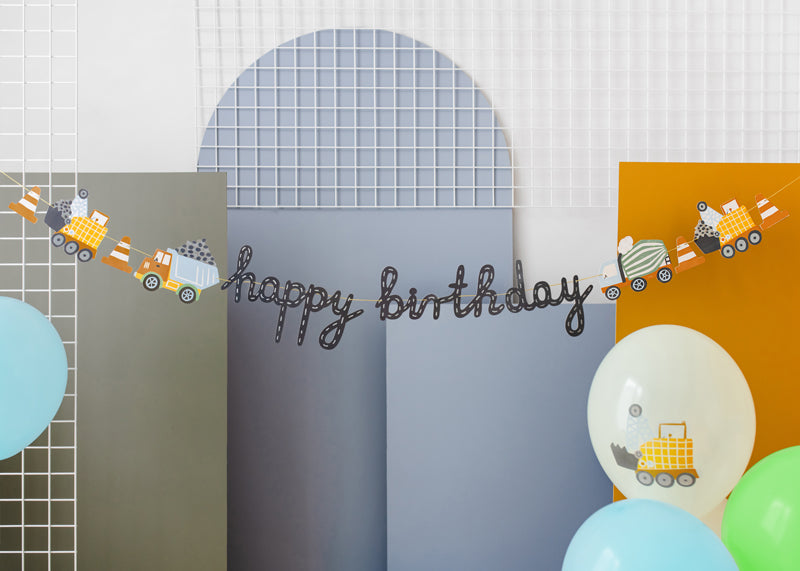 Little Builder birthday banner detail showing construction truck and tool designs