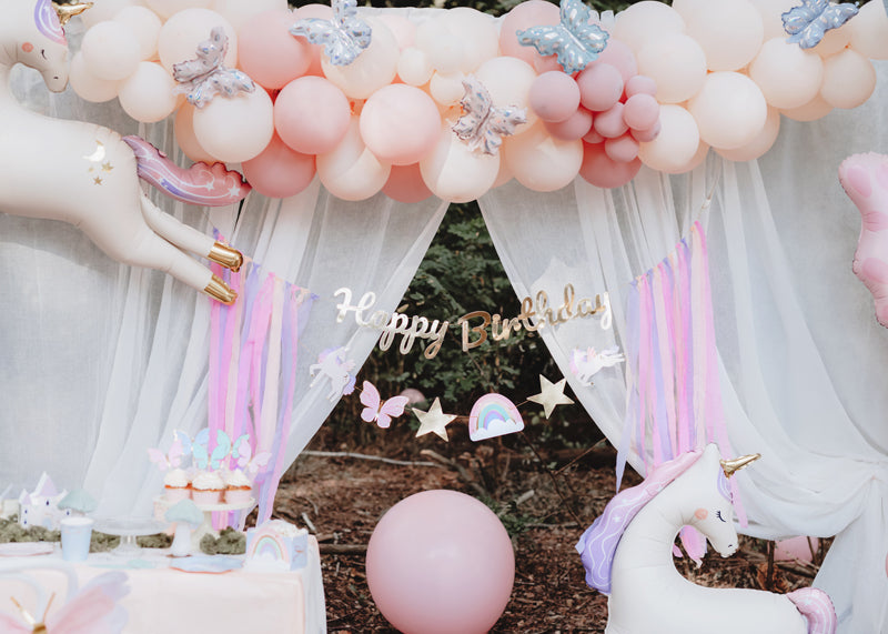 Fairytale Magic birthday banner styled with pastel party decorations and stars