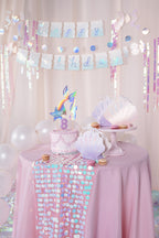 Making Waves birthday banner styled with mermaid and ocean themed party decorations