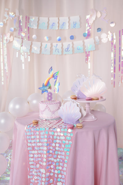Making Waves birthday banner styled with mermaid and ocean themed party decorations