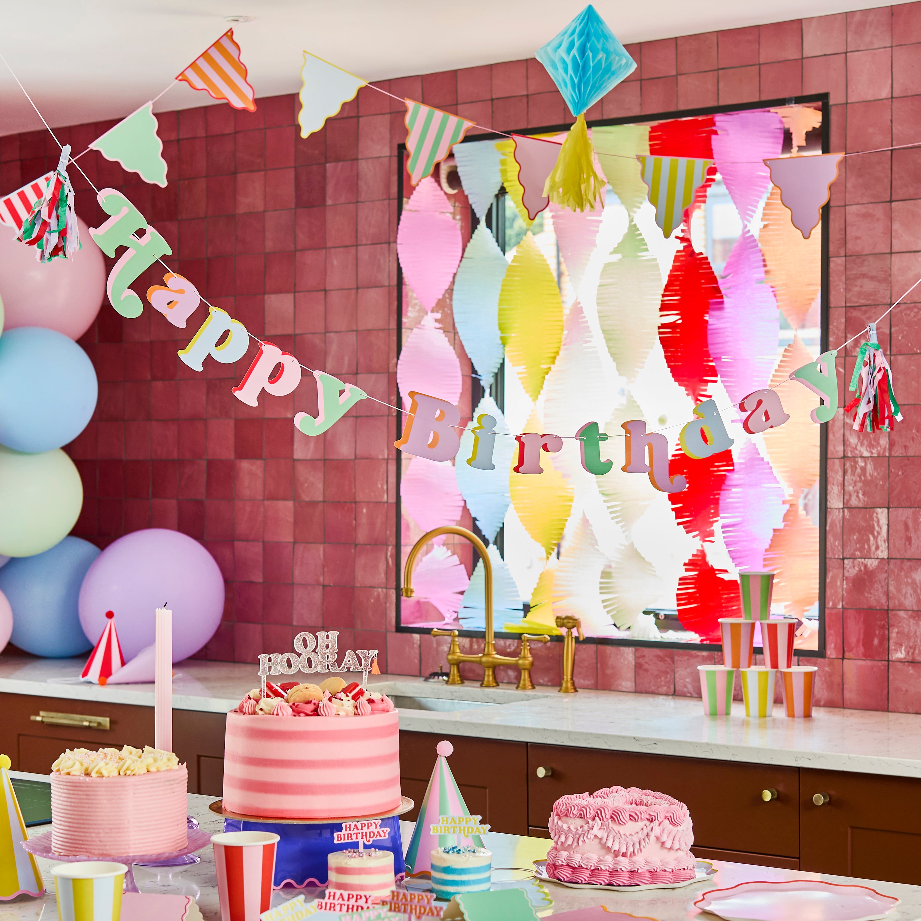 olour Block Party Happy Birthday banner detail with colorful letters and tassel decorations