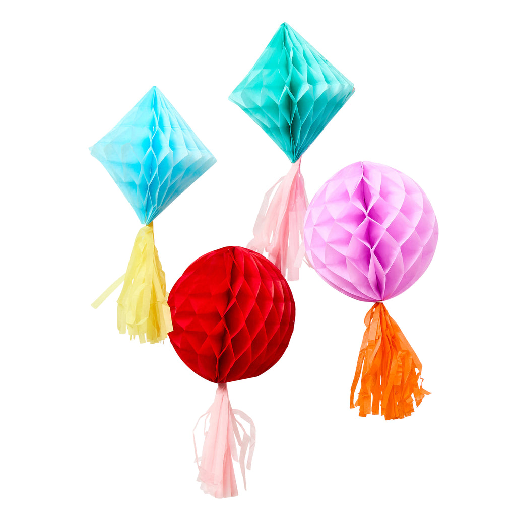 Colorful paper honeycomb decorations with tassels on a white background