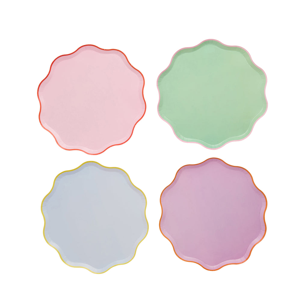 Coloured plates with scalloped edges on a white background