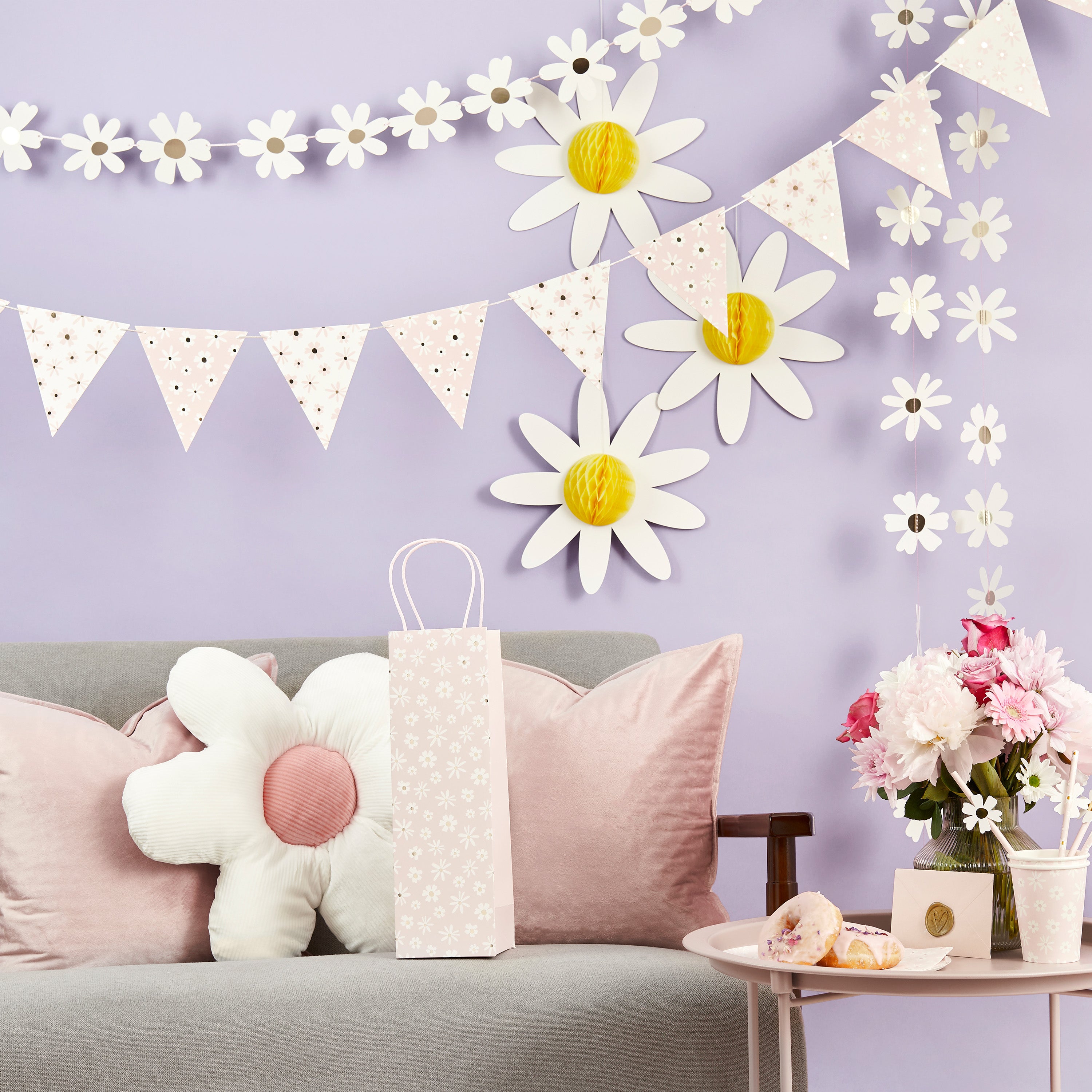 Daisy Days party decorations styled together with hanging garland and tableware