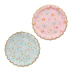 A set of 8 scalloped-edge plates with a floral garden design, perfect for serving food at a tea party.