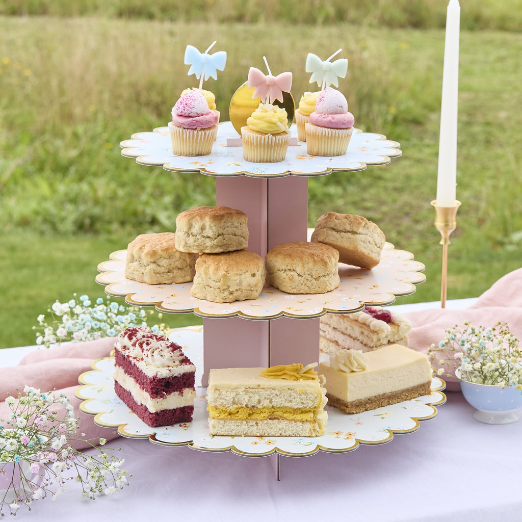 A delicate tiered cake stand featuring floral patterns, perfect for serving treats at a garden tea party.