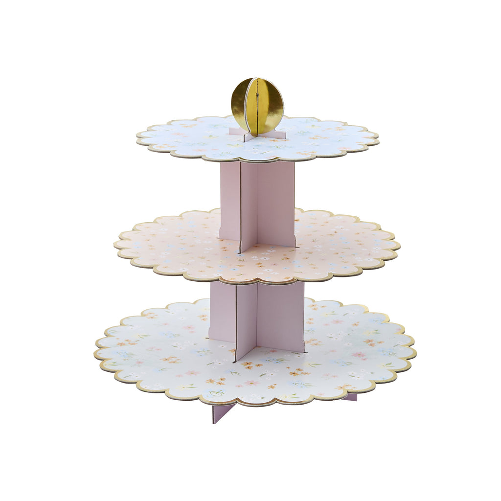 A delicate tiered cake stand featuring floral patterns, perfect for serving treats at a garden tea party.
