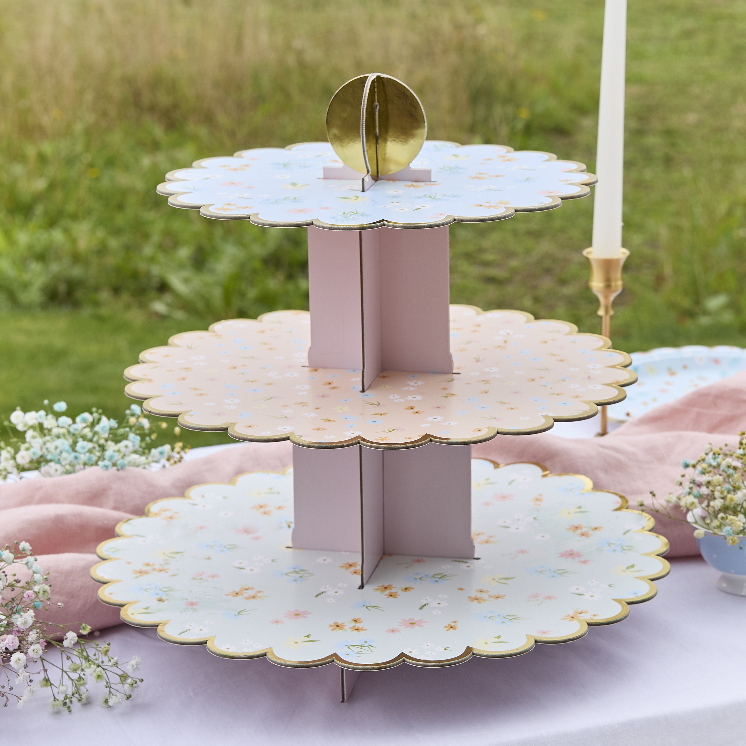 A delicate tiered cake stand featuring floral patterns, perfect for serving treats at a garden tea party.
