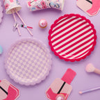Pamper Party plates detail showing striped and checkered beauty themed designs and products