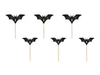 Black bat-shaped cupcake toppers on sticks against a white background