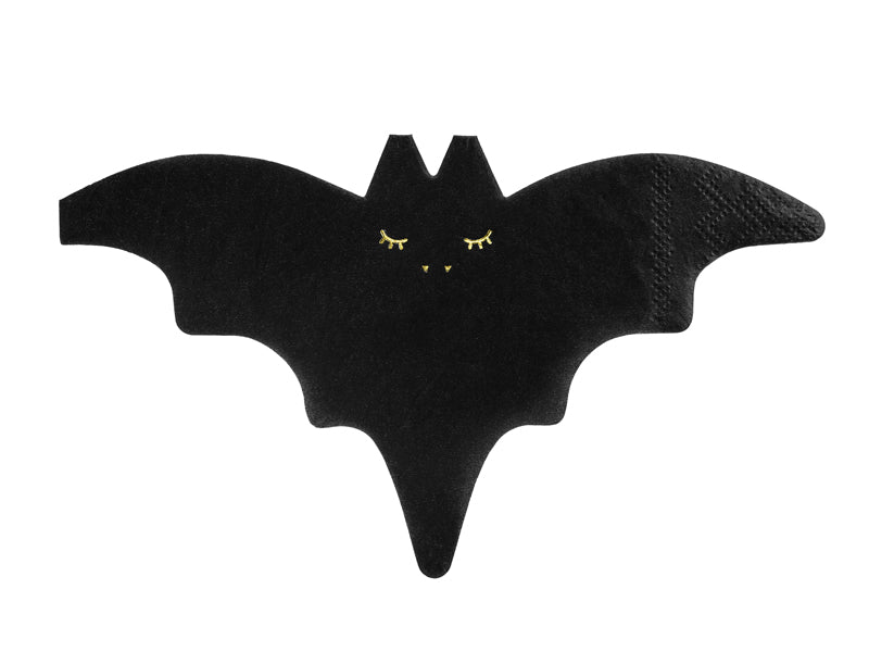 Black bat-shaped object with gold eyes 