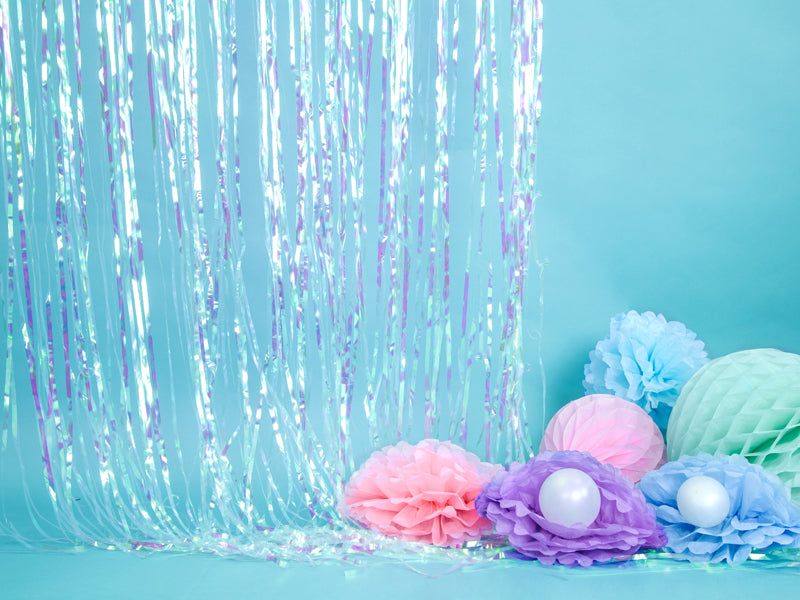 A single garland made of shimmering, iridescent pastel tassels, perfect for dreamy party settings like unicorn or mermaid themes.