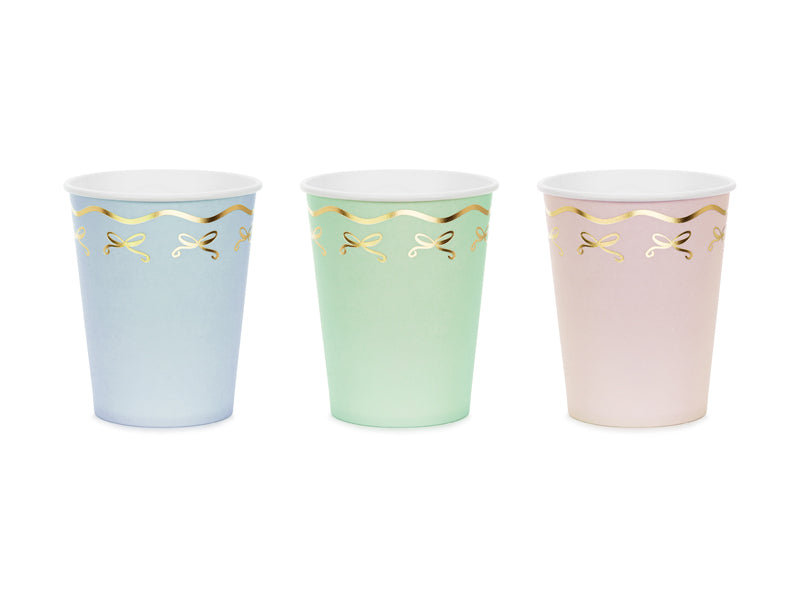 A set of 6 paper cups with a dainty bow motif, great for serving drinks at a magical party.