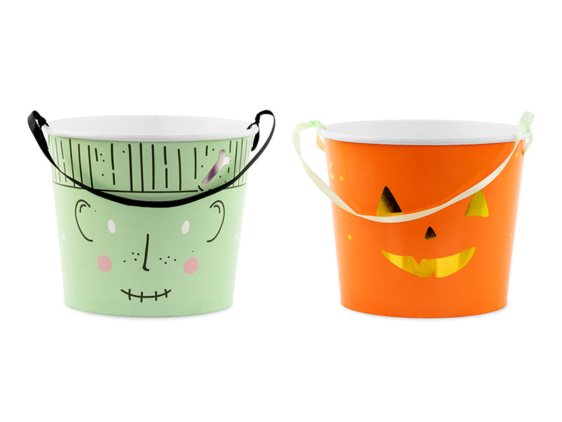 Two Halloween-themed buckets, one green with a face design and one orange with a pumpkin face design, on a white background.