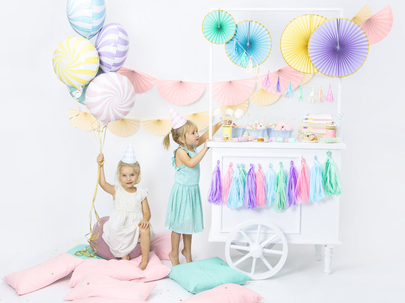 Pastel tassel garland styled as party decoration with soft color palette