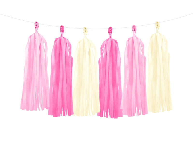 Pink and yellow tassel decorations hanging on a string against a white background
